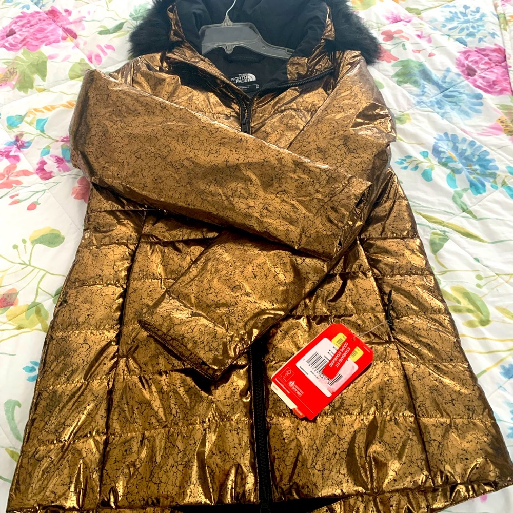 NWT. Gold North Face jacket with black fur around the hood. Size medium